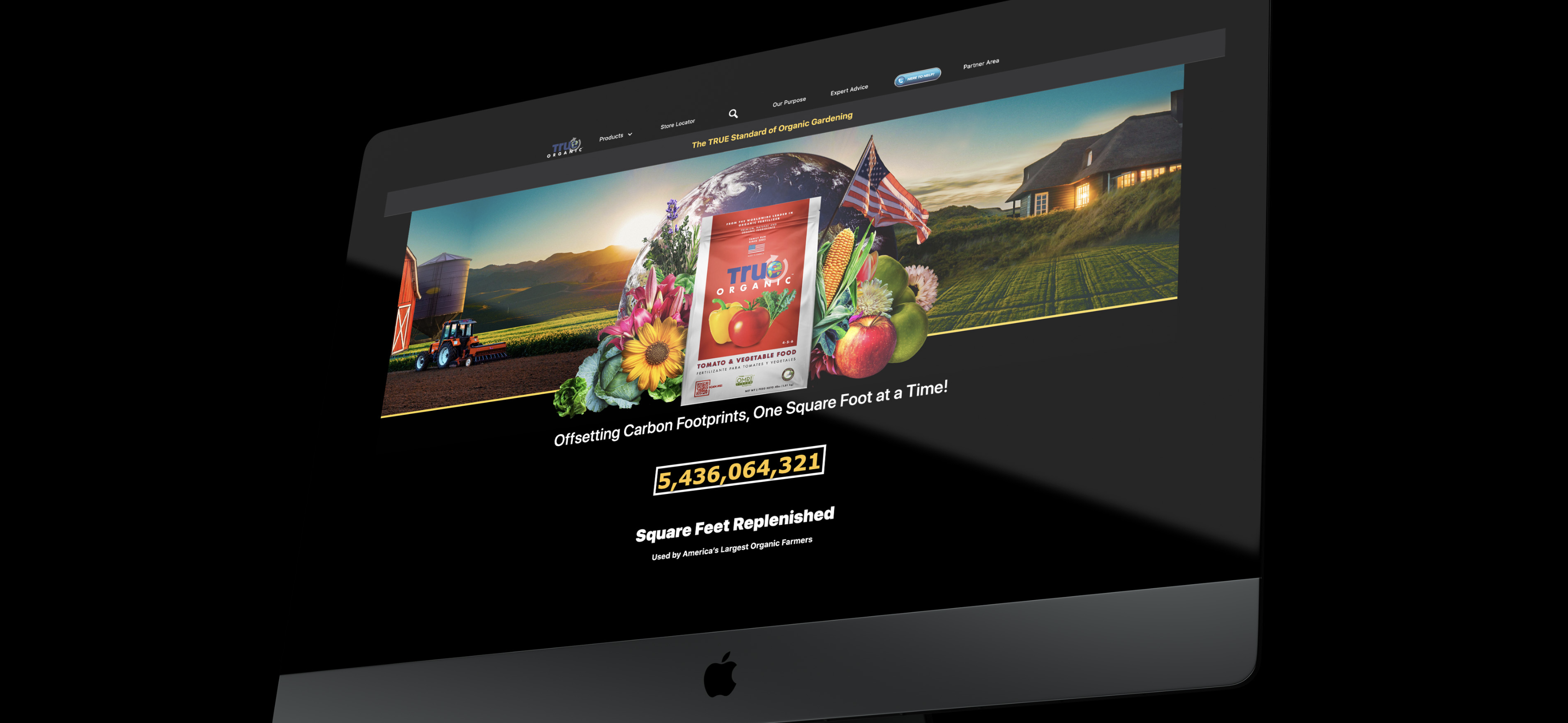 A render of the True Organic Products Website displayed on an Apple monitor